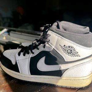 The Air Jordan 1 Mid White Black is a mid-top sneaker used some life left